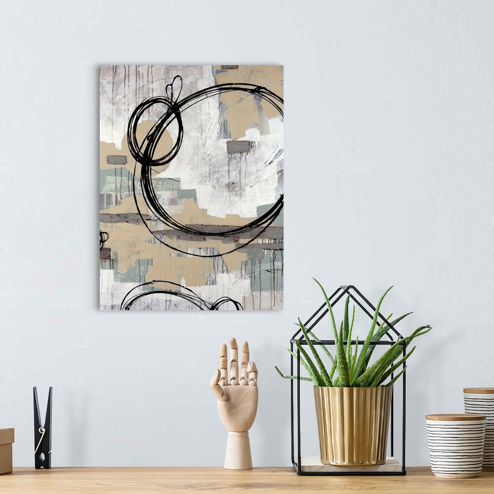 A bohemian room featuring Abstract painting with neutral colors in rectangle splotches in the background with dark ring cir...