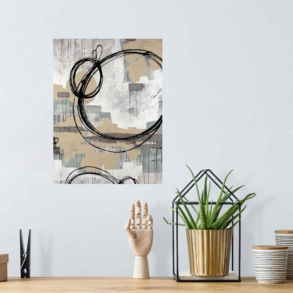 A bohemian room featuring Abstract painting with neutral colors in rectangle splotches in the background with dark ring cir...