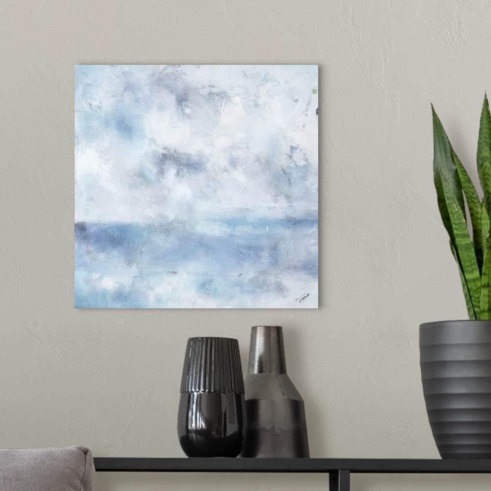 A modern room featuring Square abstract painting in shades of blue, gray, and white with a foggy feel.