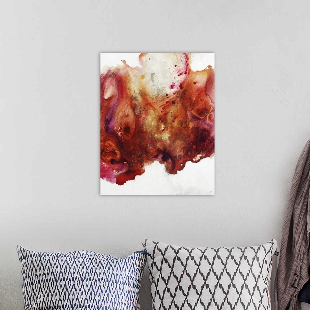 A bohemian room featuring Large abstract painting of vibrant colors of orange, red and pink.