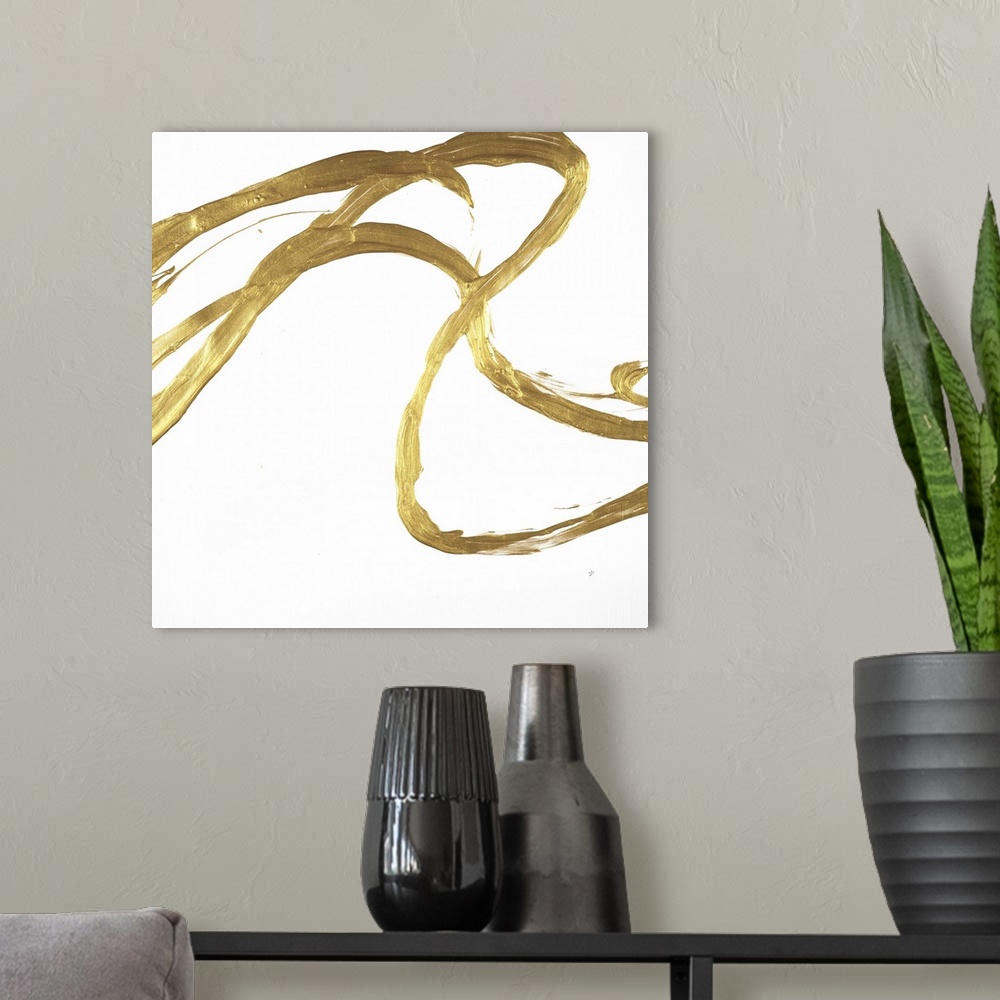 A modern room featuring Square minimalist abstract artwork with metallic gold brushstrokes on a white background.