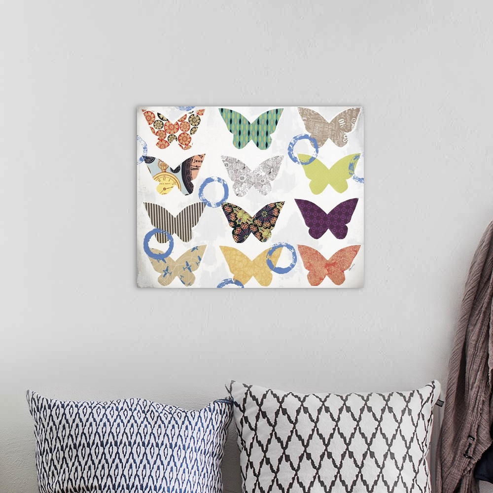 A bohemian room featuring Contemporary mixed media artwork with colorful, patterned butterflies pasted onto a white and gra...