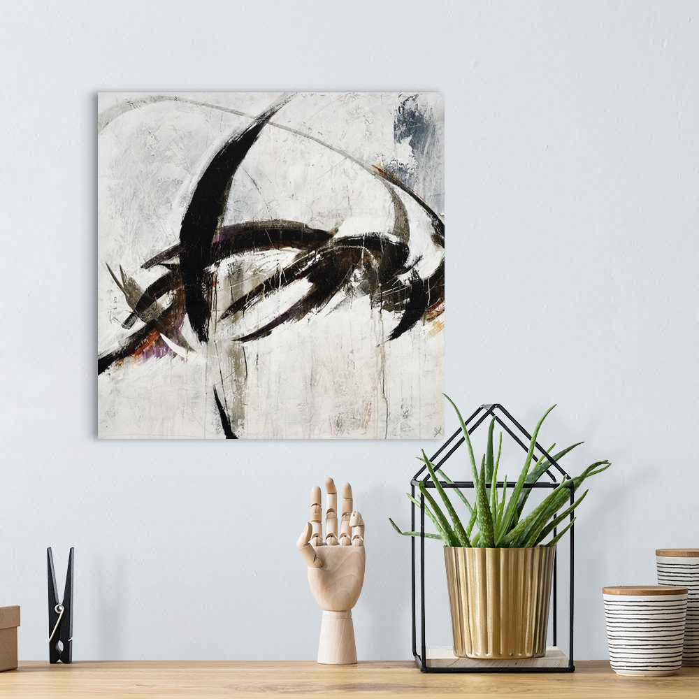 A bohemian room featuring Abstract painting using harsh black paint strokes against a neutral background.