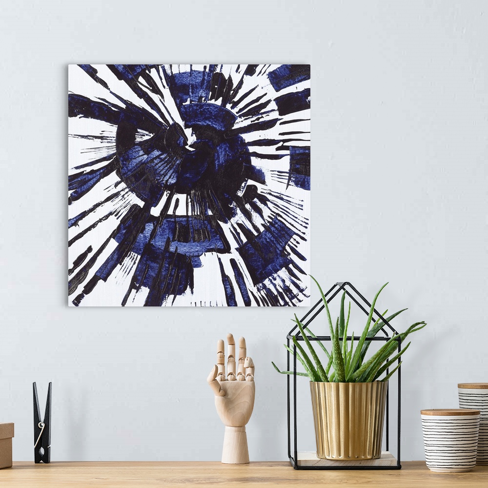A bohemian room featuring Square abstract painting with a blue circular splatter design on a gray background.
