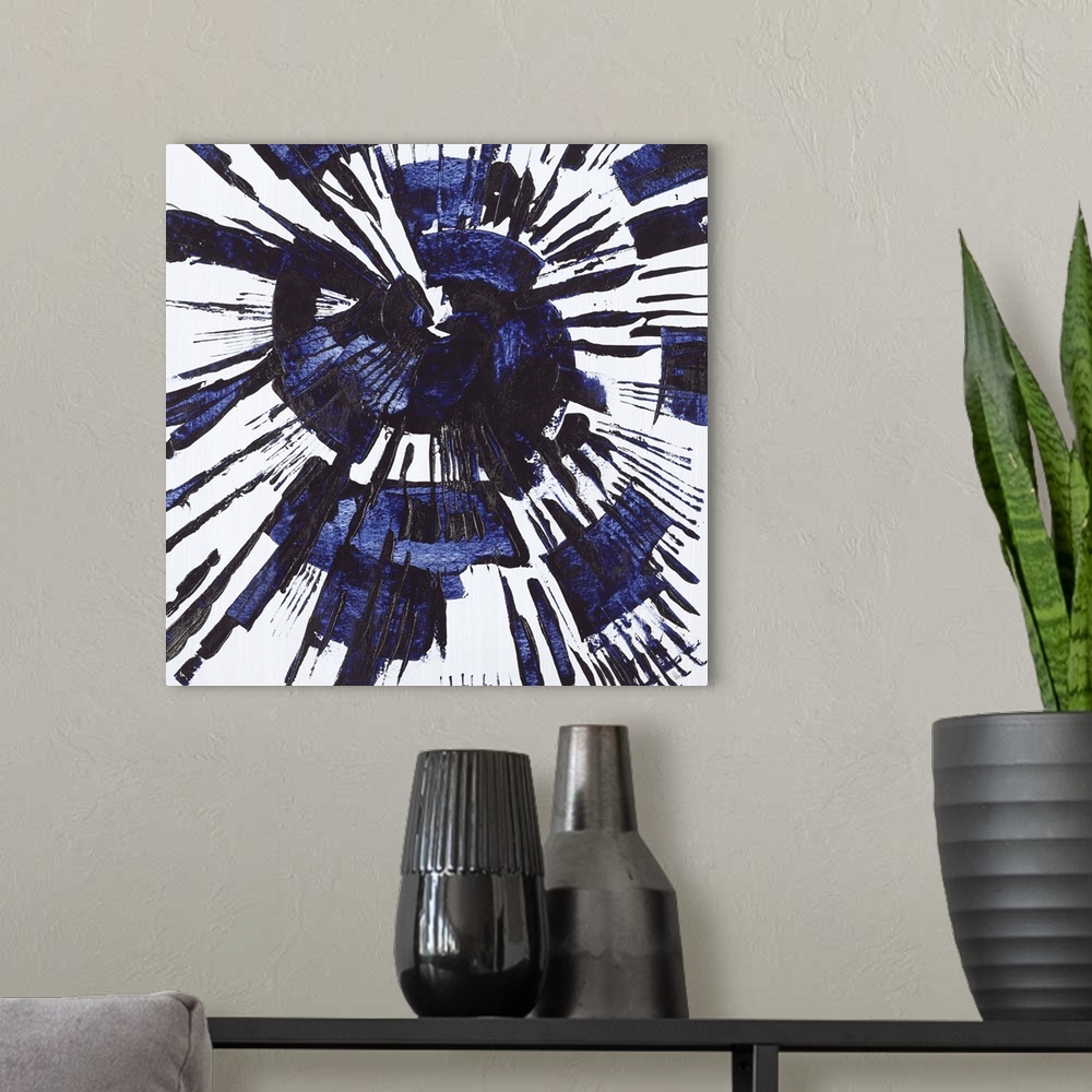 A modern room featuring Square abstract painting with a blue circular splatter design on a gray background.