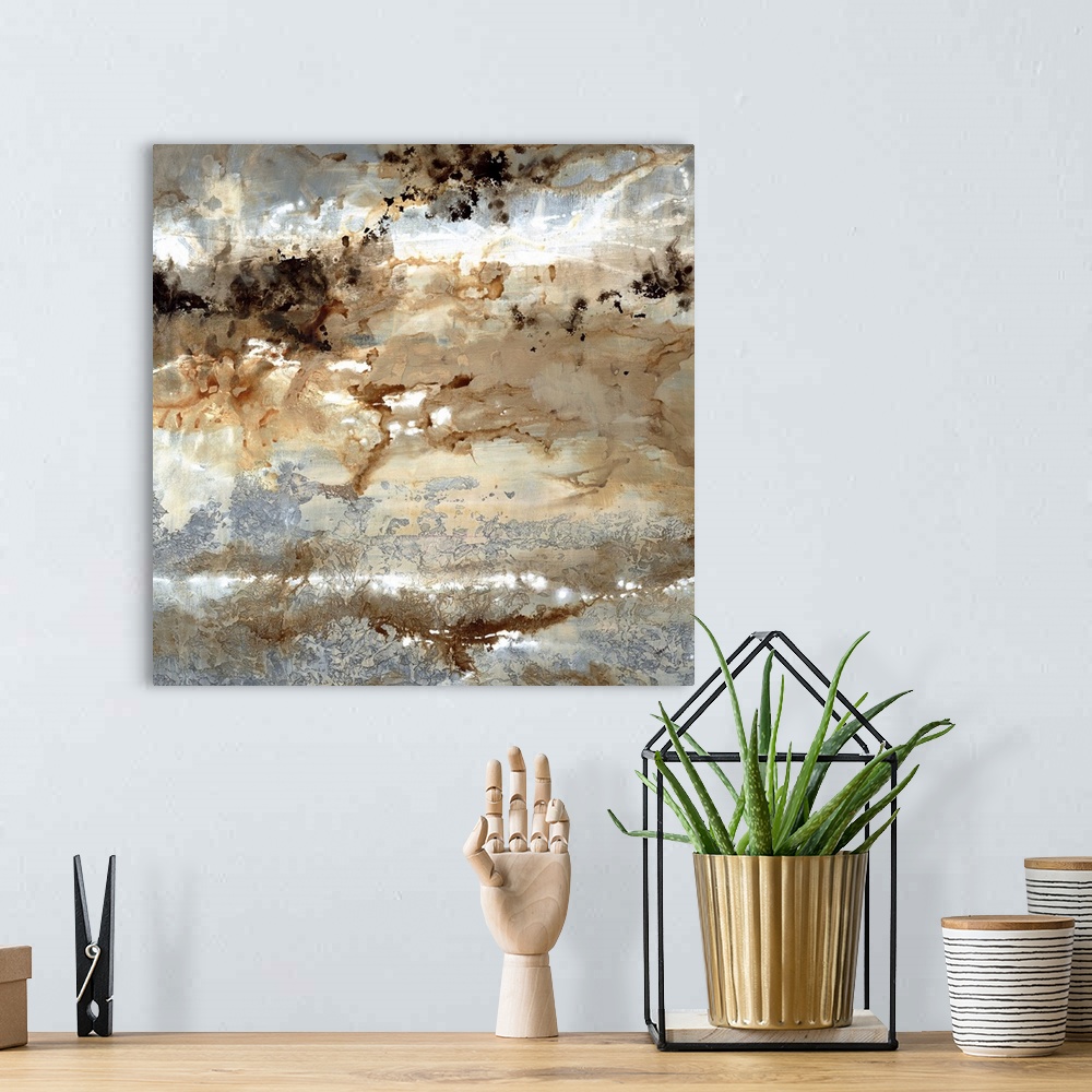A bohemian room featuring Square abstract art with silver, brown, black, and white hues.