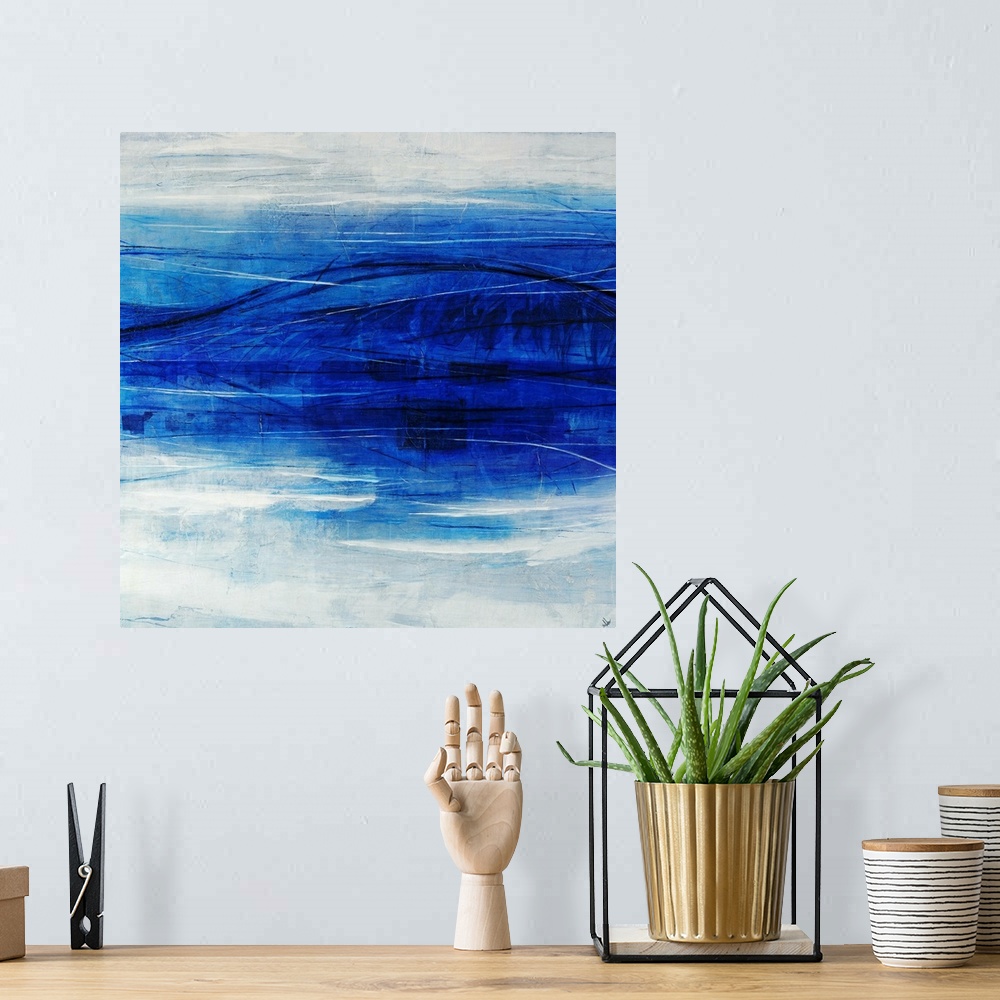 A bohemian room featuring Abstract art of a large blue wave that appears to reflect itself in the foreground, on a light ho...