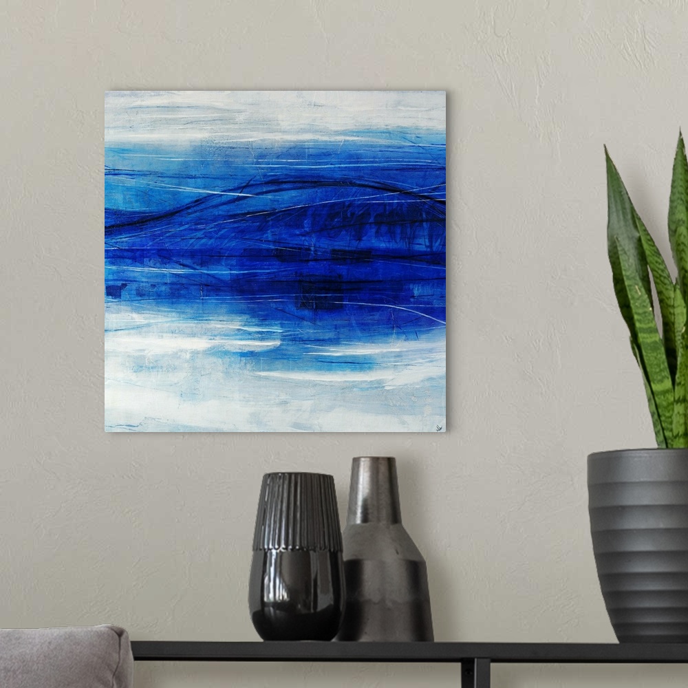 A modern room featuring Abstract art of a large blue wave that appears to reflect itself in the foreground, on a light ho...