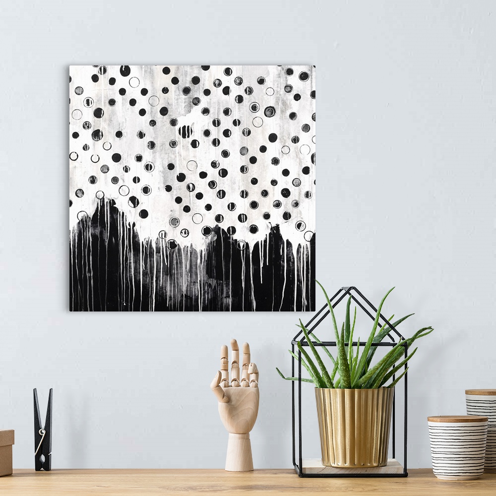 A bohemian room featuring Contemporary abstract painting in black and white, with a dripping paint effect.