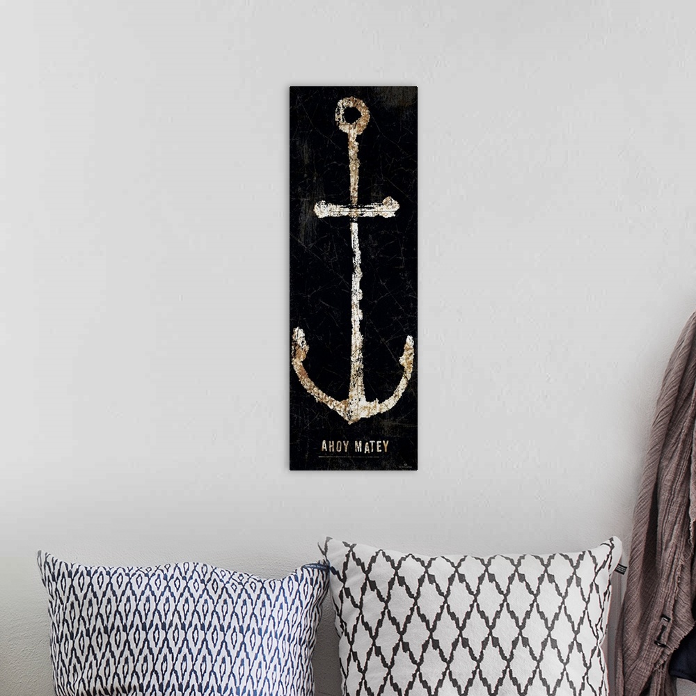 A bohemian room featuring A vertical rusty sea anchor with the words Ahoy Matey underneath on a black background.