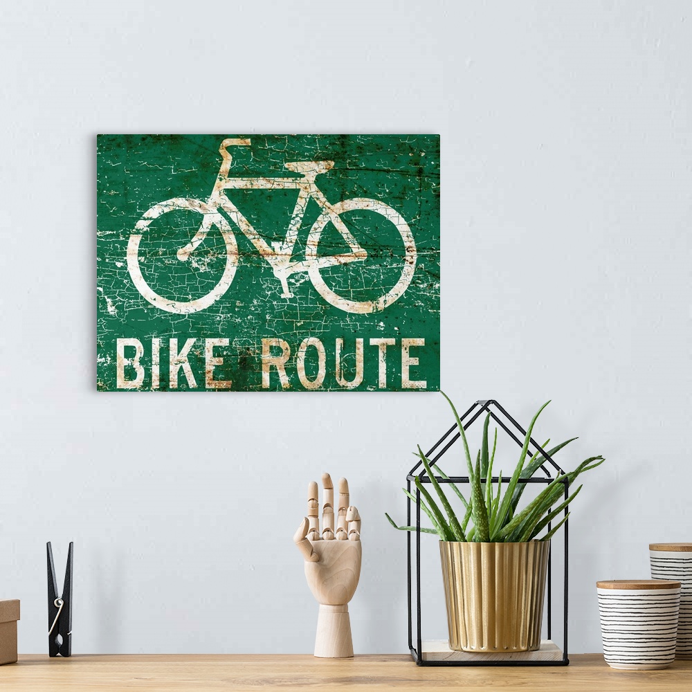 A bohemian room featuring A worn, distressed, cracked and rusty bike route street sign.