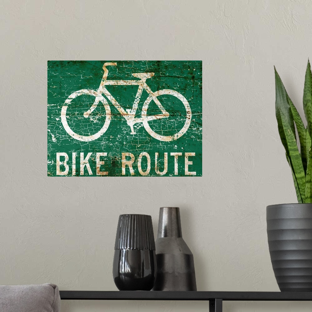 A modern room featuring A worn, distressed, cracked and rusty bike route street sign.