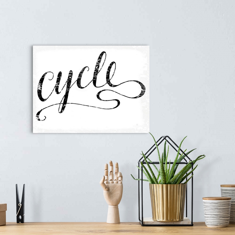 A bohemian room featuring Hand lettered script font of the word Cycle.
