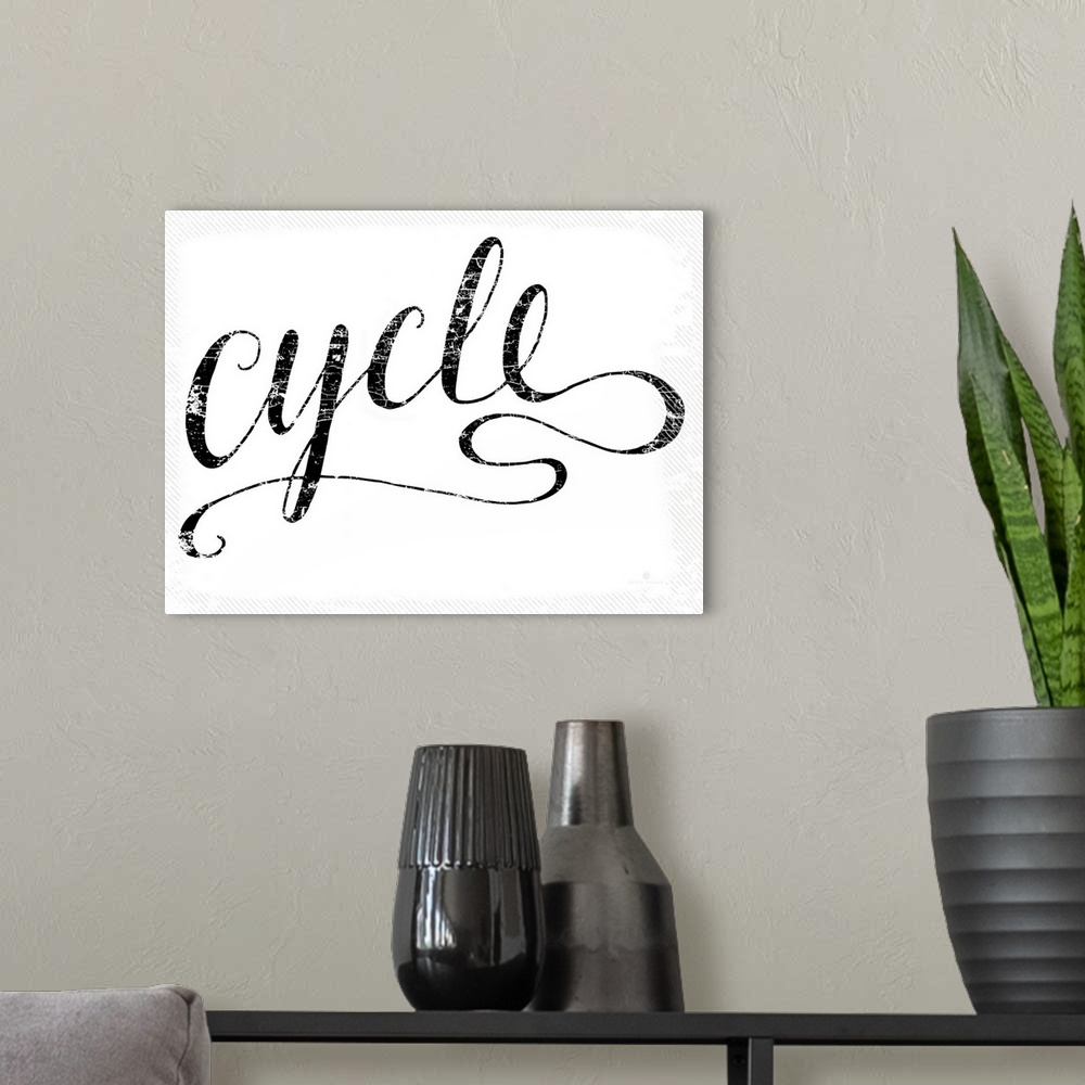 A modern room featuring Hand lettered script font of the word Cycle.
