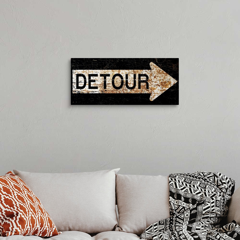 A bohemian room featuring A worn, distressed, cracked and rusty Detour street sign.