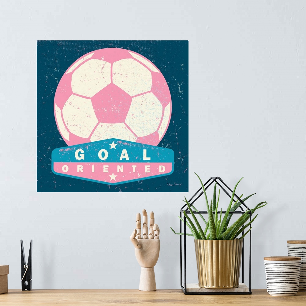 A bohemian room featuring Distressed large pink soccer ball with a typography saying "Goal Oriented"