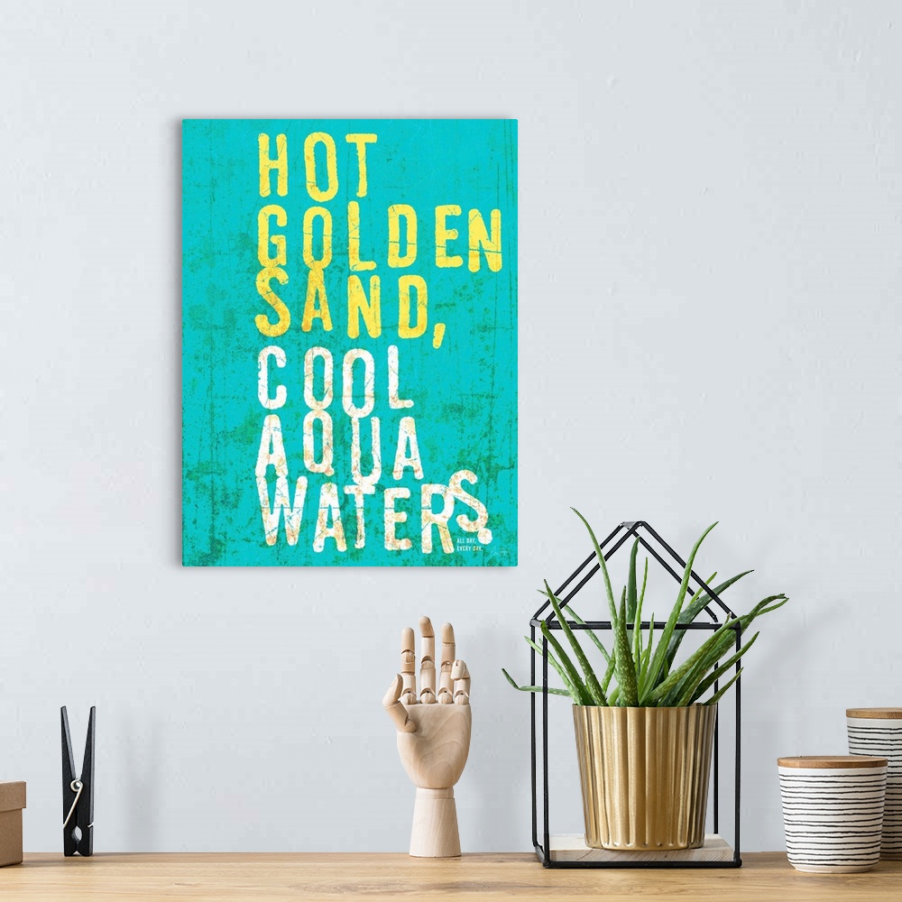 A bohemian room featuring Beach house looking wall art with distressed wording reading Hot golden sand, cool aqua waters on...