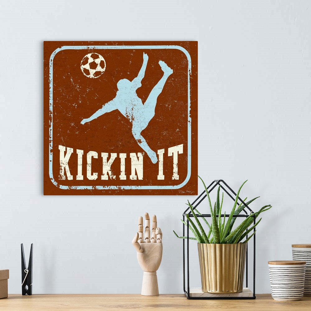A bohemian room featuring Distressed image of soccer player kicking a soccer ball with the words Kickin' It underneath.