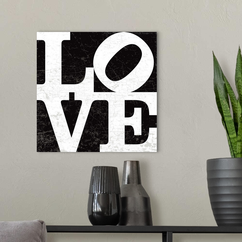 A modern room featuring A LOVE graphic with bold and distressed typography in black.