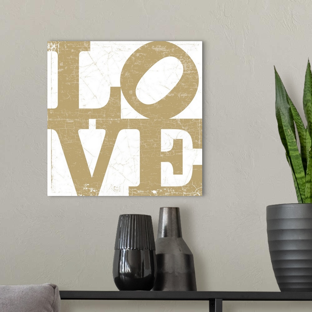 A modern room featuring A LOVE graphic with bold and distressed typography in gold.