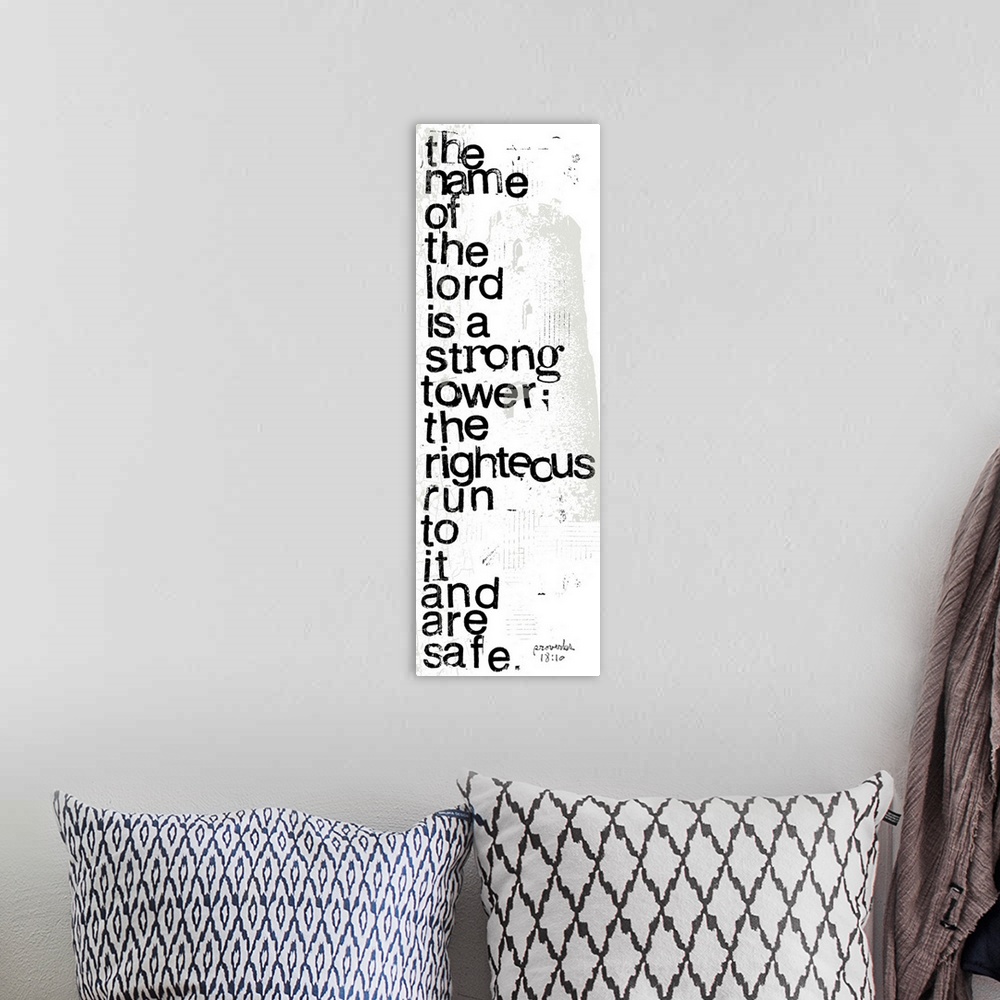 A bohemian room featuring Distressed black and white letter-stamped Bible verse scripture of Proverbs 18:10 The name of the...