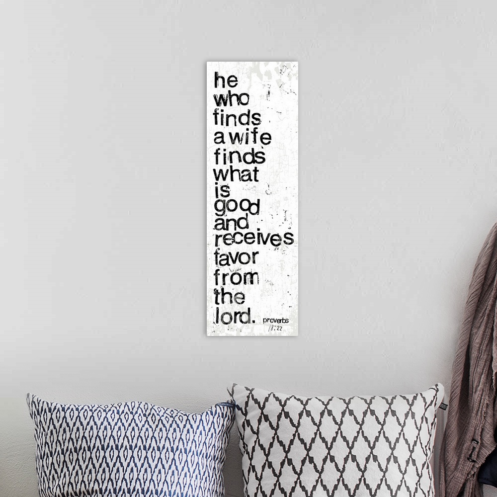 A bohemian room featuring Distressed black and white letter-stamped Bible verse scripture of Proverbs 18:22 He who finds a ...
