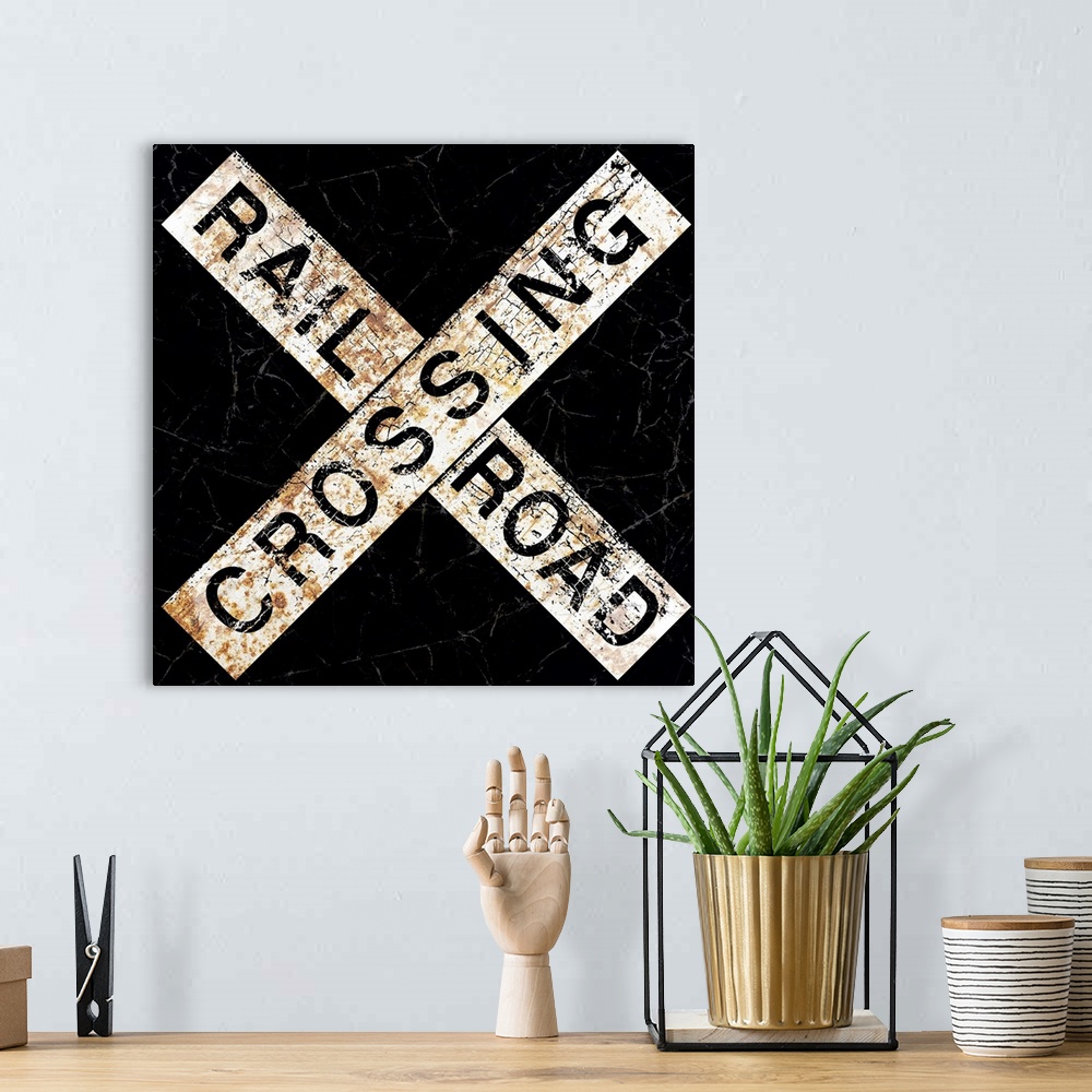A bohemian room featuring A worn, distressed, cracked and rusty Railroad Crossing street sign.
