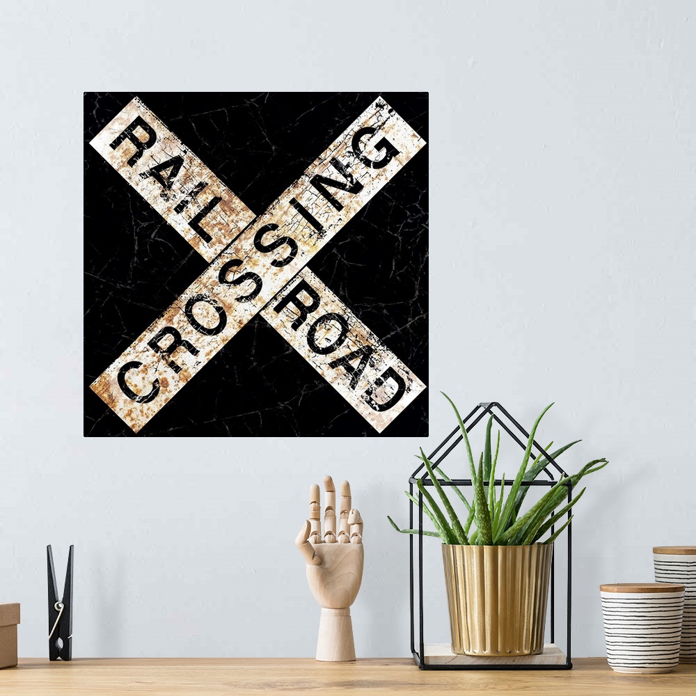 A bohemian room featuring A worn, distressed, cracked and rusty Railroad Crossing street sign.