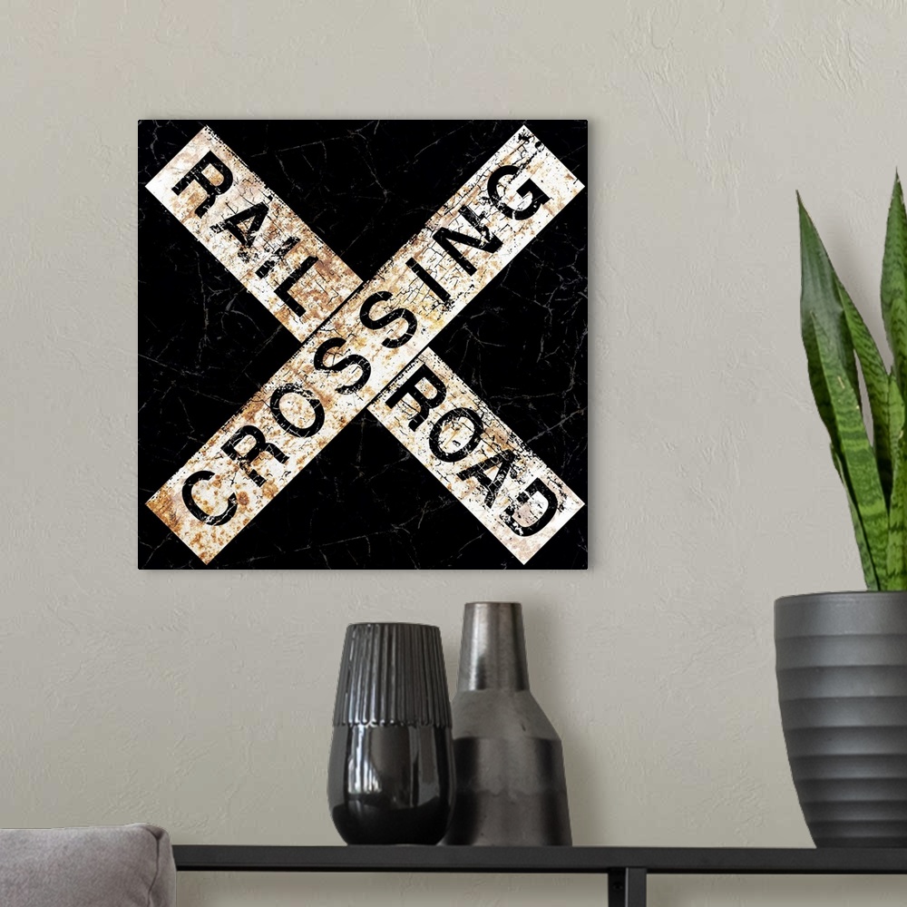 A modern room featuring A worn, distressed, cracked and rusty Railroad Crossing street sign.