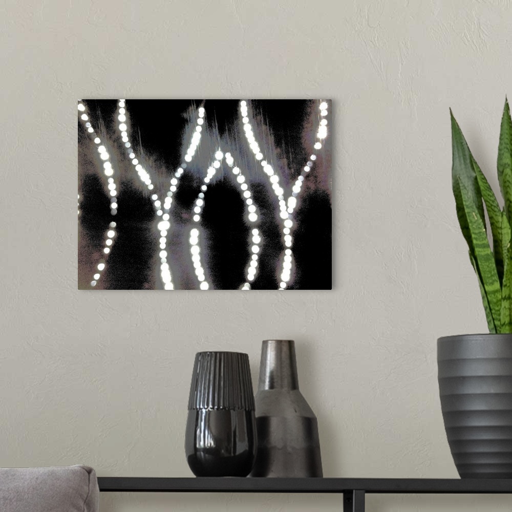 A modern room featuring An abstract of curved bright diamond dot lights on a silver, gold and black background.