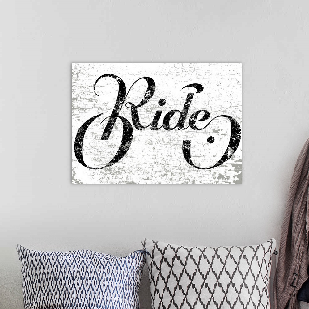 A bohemian room featuring Hand lettered script font of the word Ride in the shape of a bike.