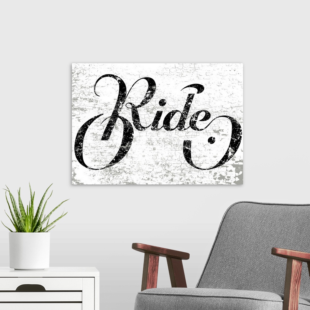 A modern room featuring Hand lettered script font of the word Ride in the shape of a bike.