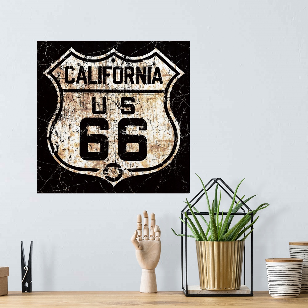 A bohemian room featuring A back and white, worn, distressed and rusty vintage Route 66 street sign.