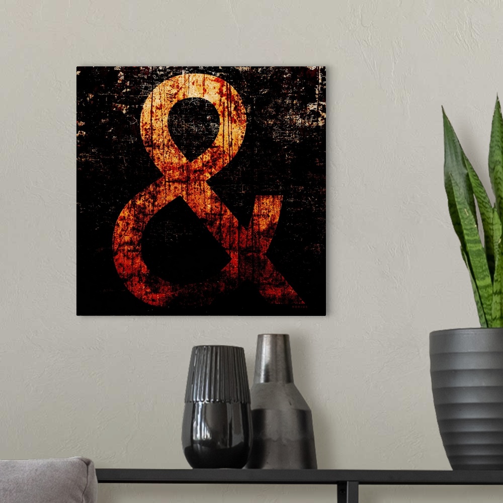A modern room featuring Rusty typography wall art of a large yellow ampersand character on black background.