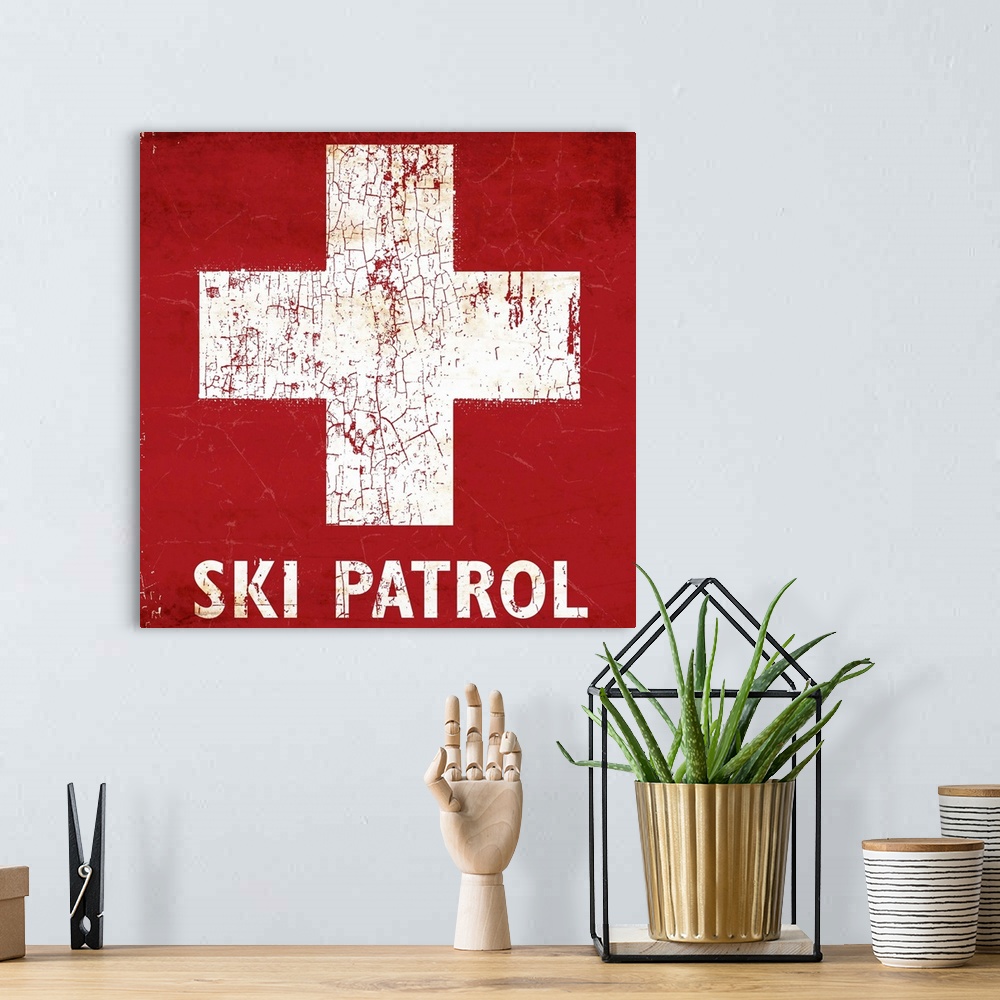 A bohemian room featuring A worn, distressed, cracked and rusty Ski Patrol ski sign.