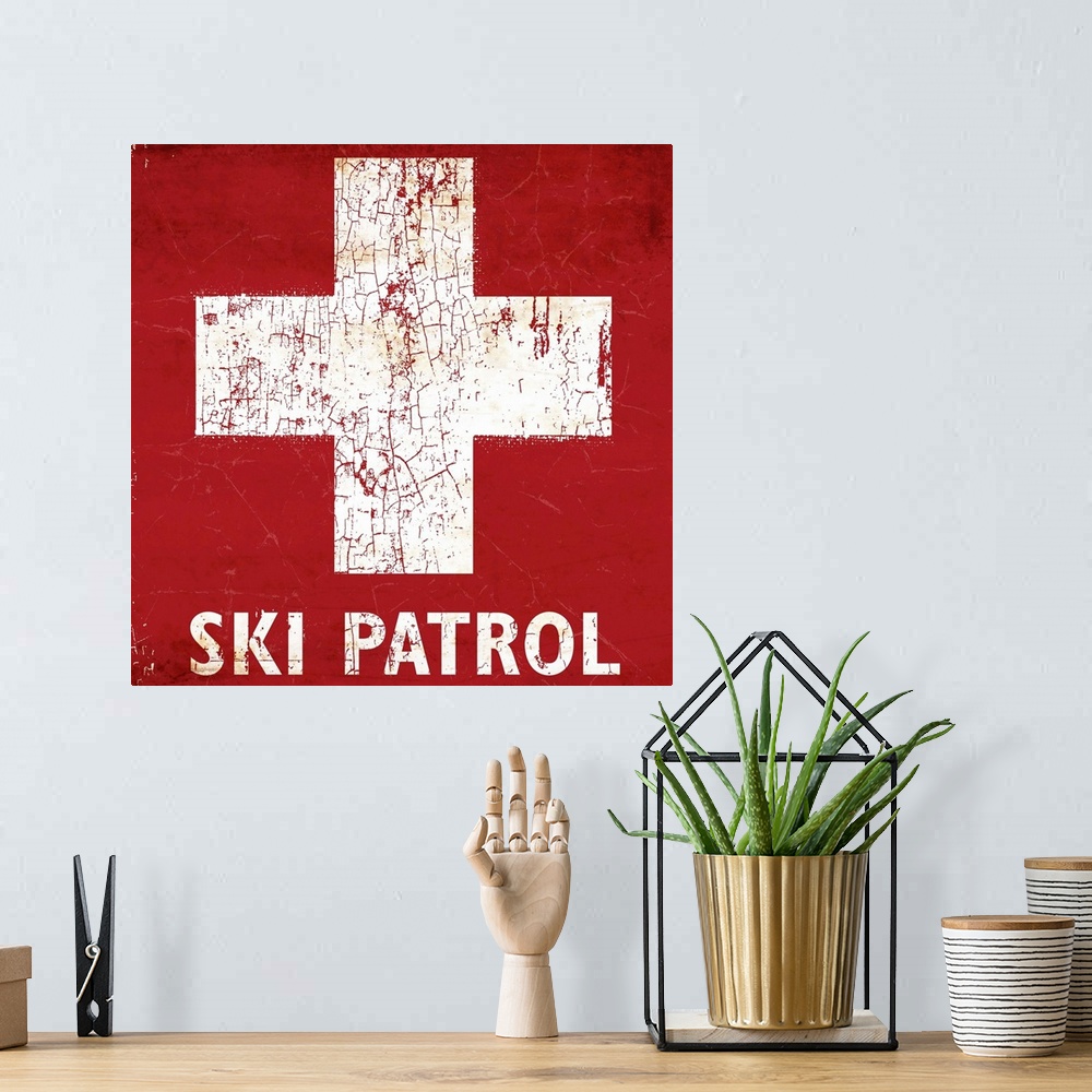 A bohemian room featuring A worn, distressed, cracked and rusty Ski Patrol ski sign.
