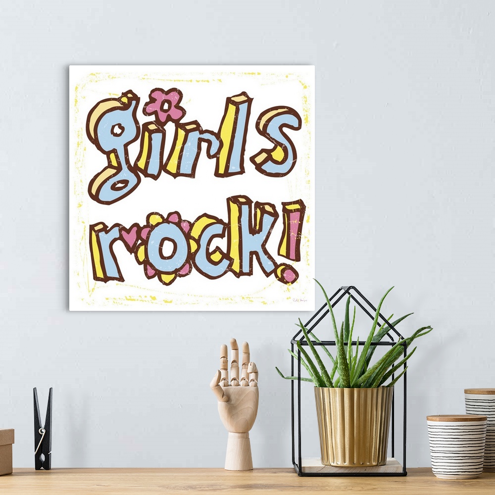 A bohemian room featuring The words "Girls Rock" handwritten in pen and ink.