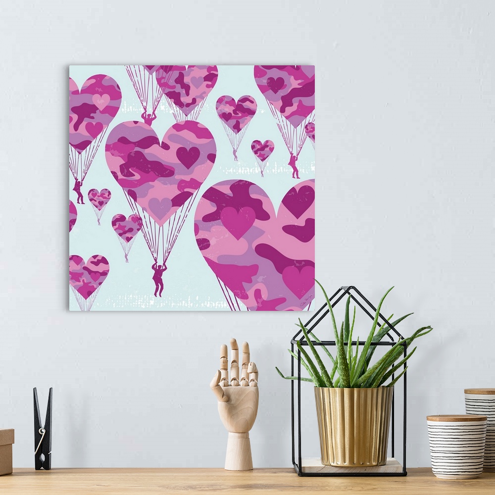 A bohemian room featuring Graphic art of paratroopers with pink camoflauge parachutes in the shape of hearts.
