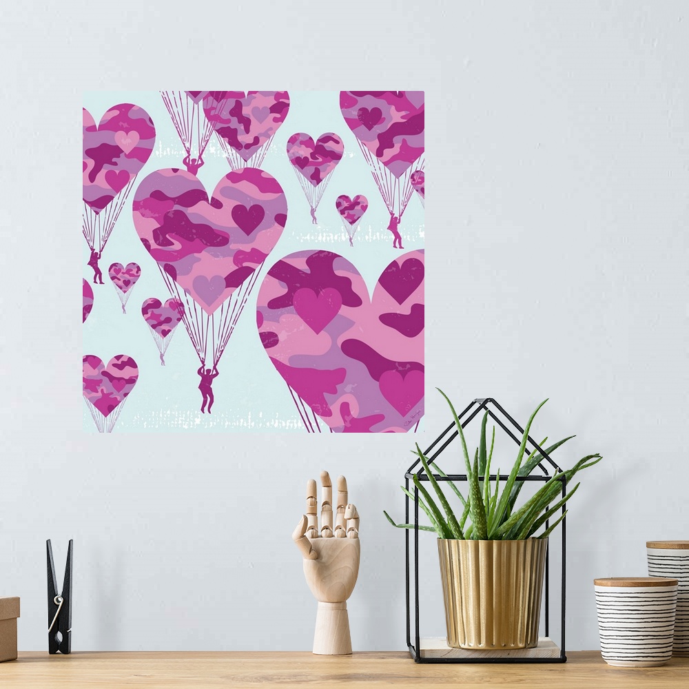 A bohemian room featuring Graphic art of paratroopers with pink camoflauge parachutes in the shape of hearts.