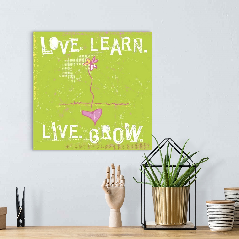 A bohemian room featuring Typography words Love. Learn. Live. Grow. arranged around a daisy with a heart as the root.
