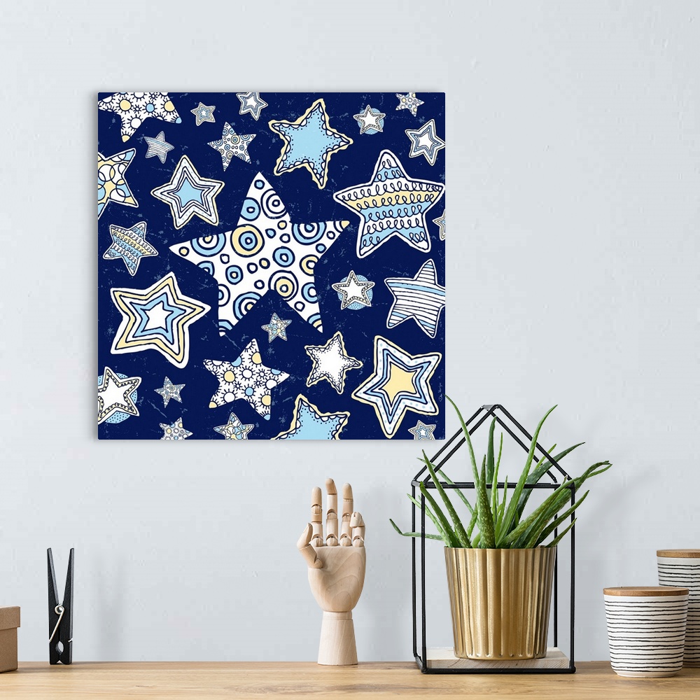 A bohemian room featuring A group of pen and ink illustrated stars, from large to small stars on a midnight blue background.