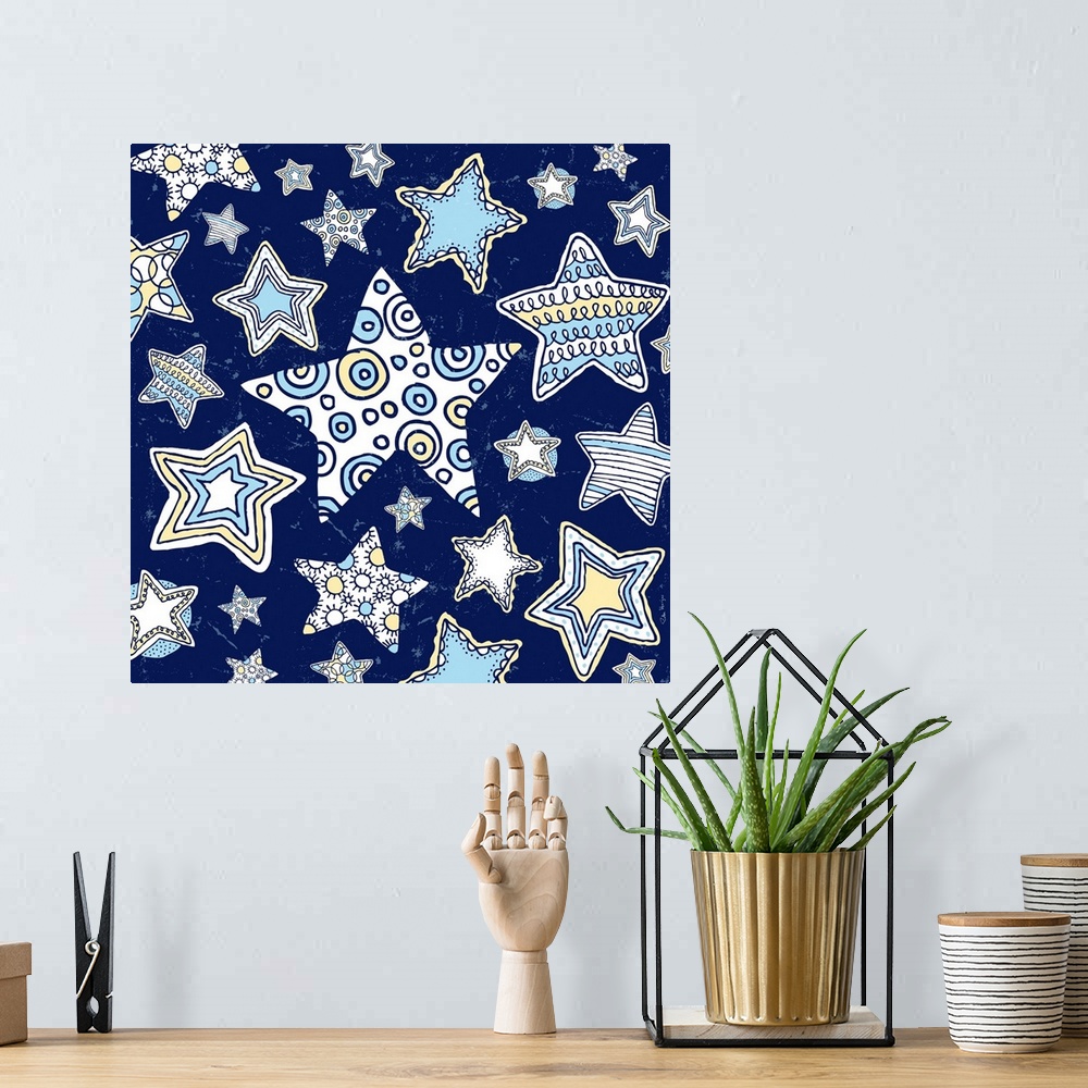 A bohemian room featuring A group of pen and ink illustrated stars, from large to small stars on a midnight blue background.