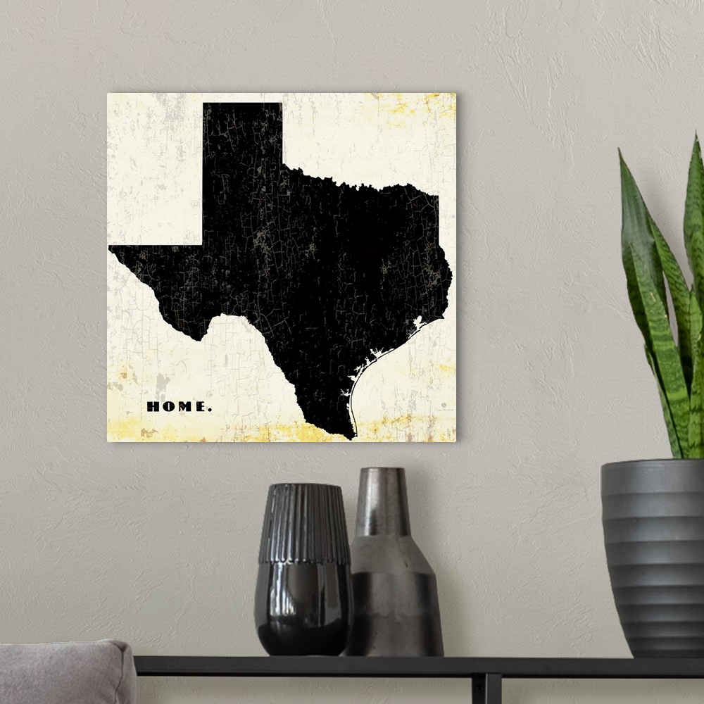 A modern room featuring Distressed wall art graphic art of the state of Texas with the word home in the lower left corner...