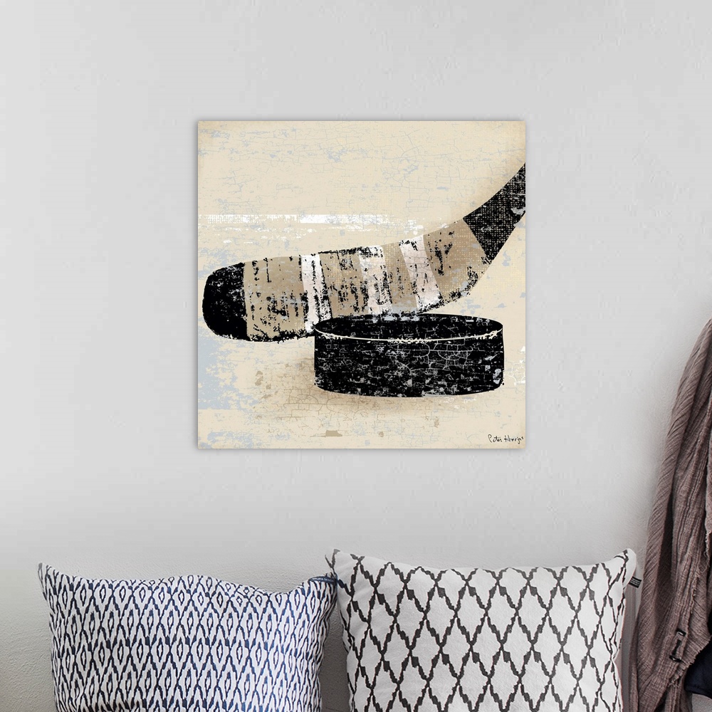 A bohemian room featuring Vintage style wall art of an old distressed hockey stick and puck on tan and sepia background.