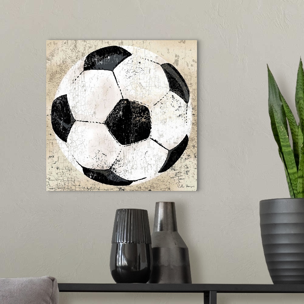 A modern room featuring Vintage style wall art of an old distressed soccer ball on tan and sepia background.