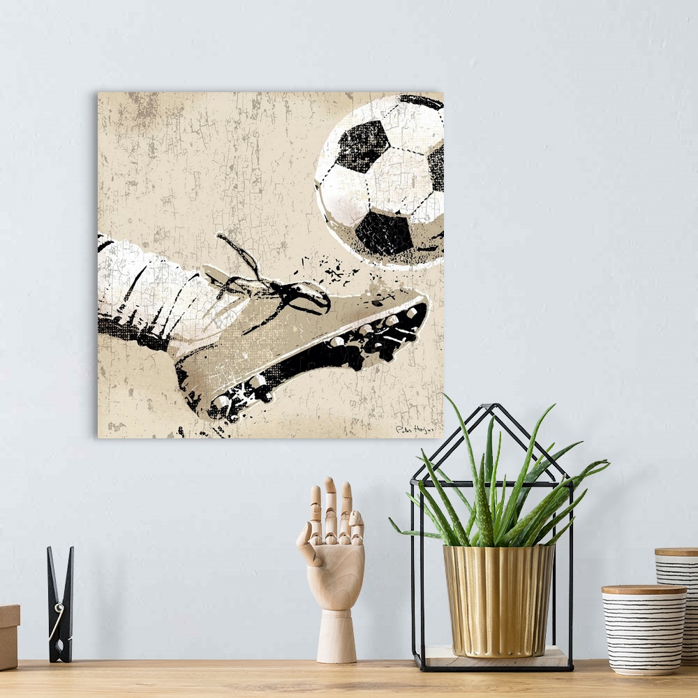 A bohemian room featuring Vintage style wall art of an old distressed soccer cleat and foot striking soccer ball on tan and...