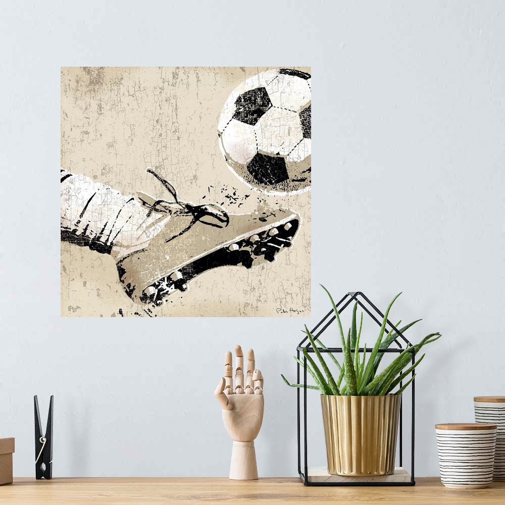 A bohemian room featuring Vintage style wall art of an old distressed soccer cleat and foot striking soccer ball on tan and...