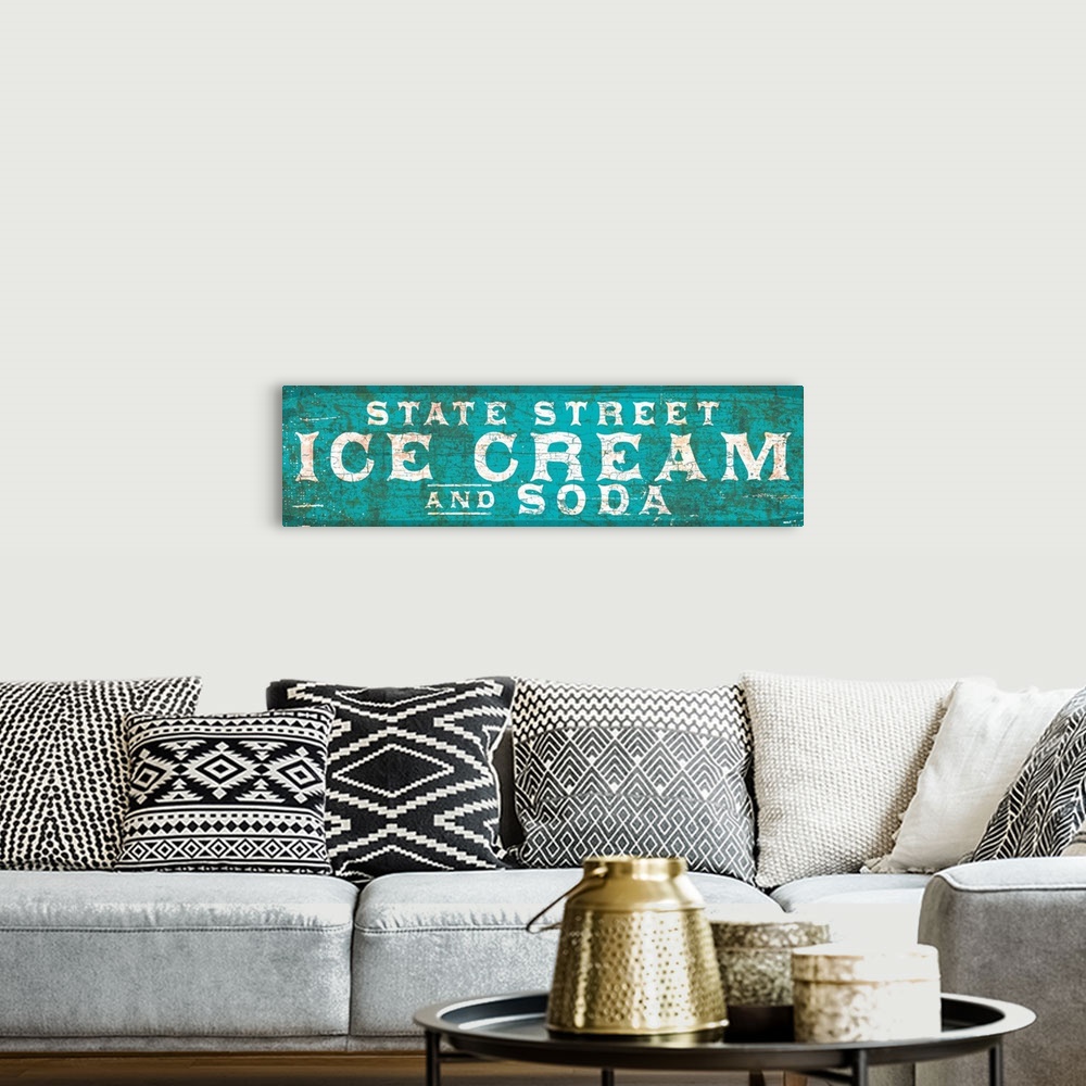 A bohemian room featuring Vintage rusty 1890's distressed trade sign wall art with typography reading State Street Ice Cream.