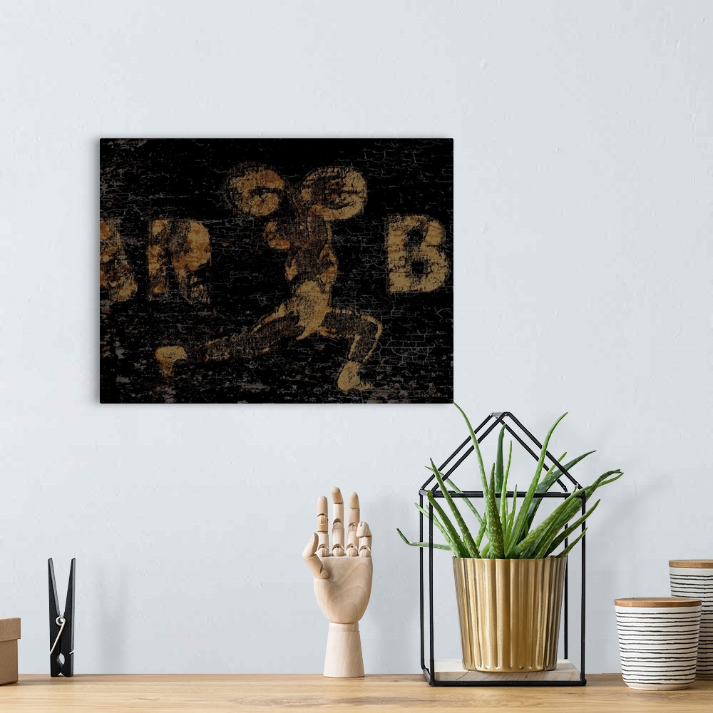 A bohemian room featuring Distressed vintage wall art of a gold image of a weightlifter with barbell overhead on a black ba...