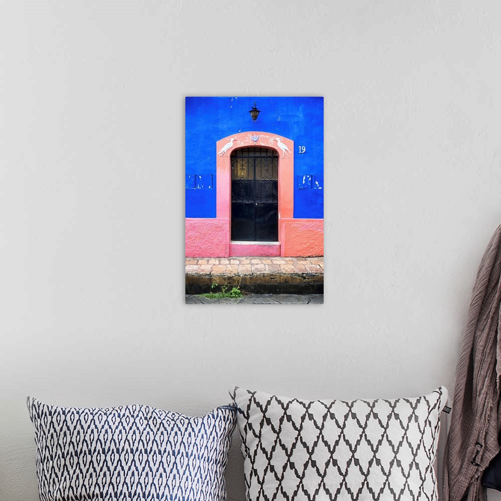 A bohemian room featuring Photograph of the blue and pink exterior to a building highlighting the doorway. From the Viva Me...